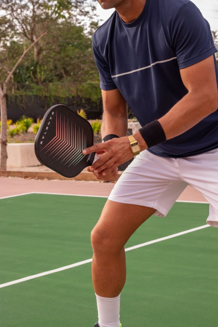 Player trying out a pickleball paddle on court